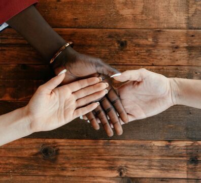 A photo showing the palms of three people of different ethnicities