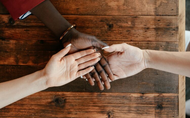 A photos showing the palms of three people of different ethnicities