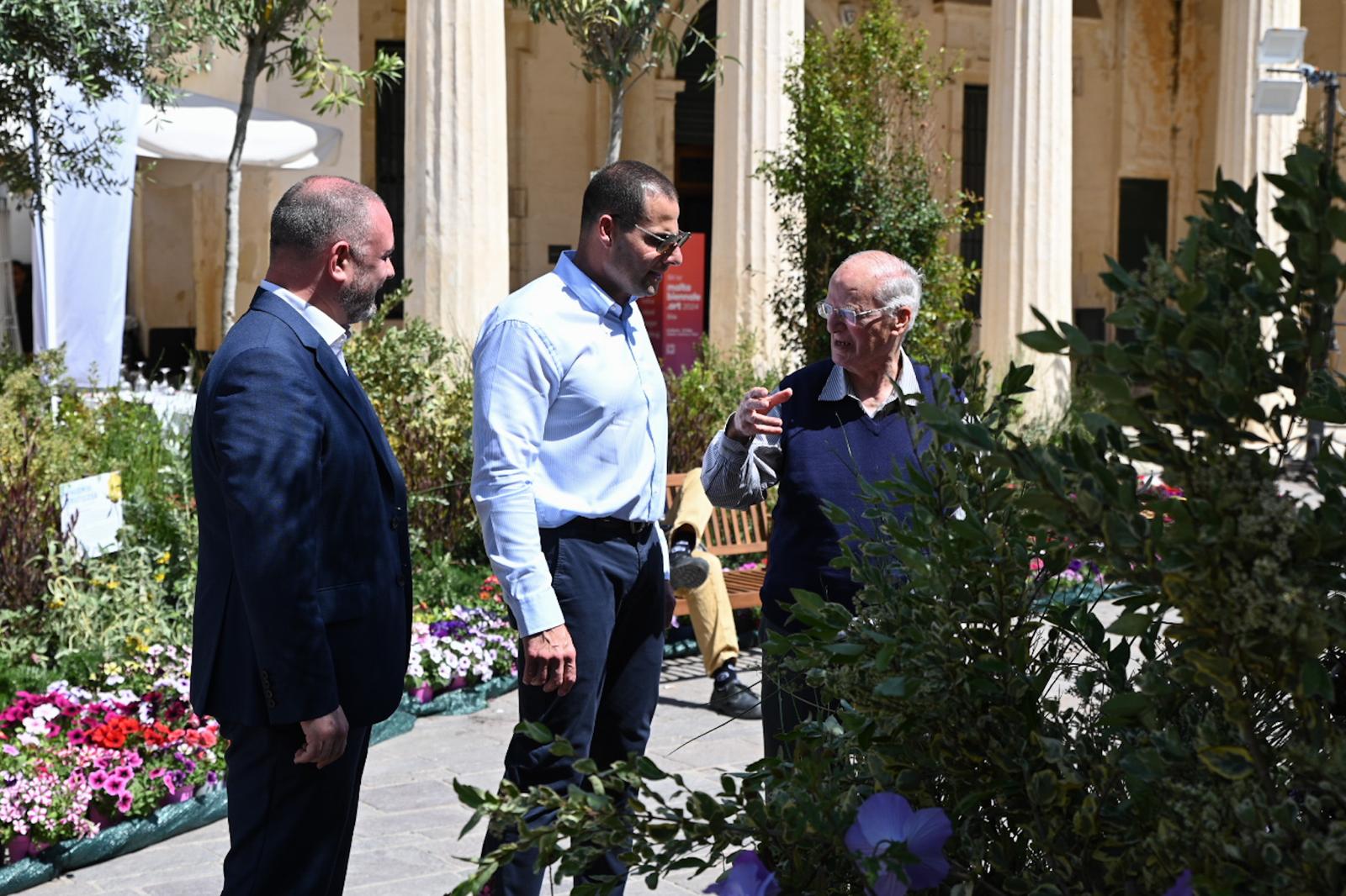 A photo showing Prime Minister Robert Abela accompanied by Minister Owen Bonnici talking to a passer-by at the Valletta Green Festival 