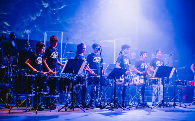 A scene from TISBIT, a dynamic percussion concert by The Clef House students, featuring a mix of percussionists, a rhythm section, and guest singers, under the direction of Michael Camilleri at Teatru Manoel.