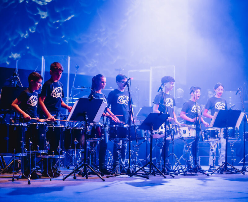 A scene from TISBIT, a dynamic percussion concert by The Clef House students, featuring a mix of percussionists, a rhythm section, and guest singers, under the direction of Michael Camilleri at Teatru Manoel.