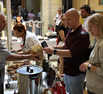 A photo showing people enjoying the Valletta Local Food Festival at the Upper Barrakka Gardens, surrounded by stalls filled with local produce, artisanal food, and traditional Maltese flavours.