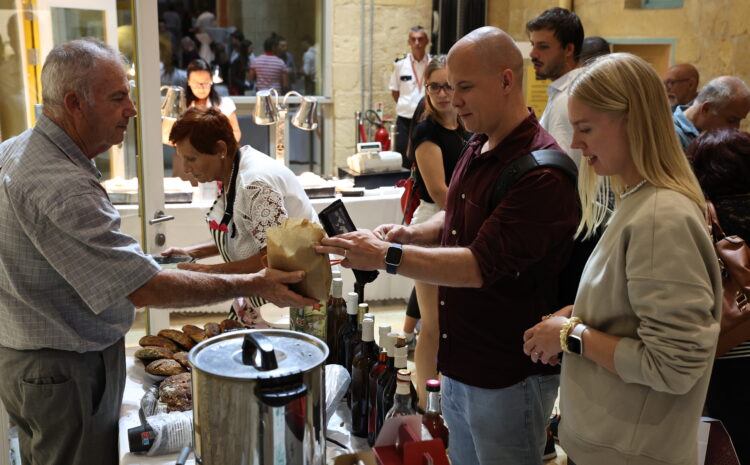 A photo showing people enjoying the Valletta Local Food Festival at the Upper Barrakka Gardens, surrounded by stalls filled with local produce, artisanal food, and traditional Maltese flavours.