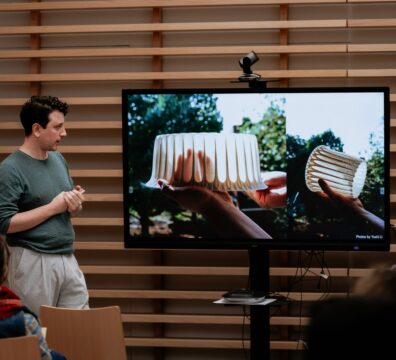 A photo showing a speaker and the audience at one opf the past FiftSix Design Talks