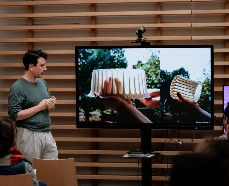 A photo showing a speaker and the audience at one opf the past FiftSix Design Talks