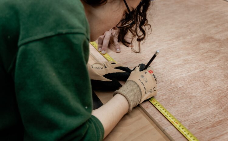 An image showing a person taking measurements in a workshop