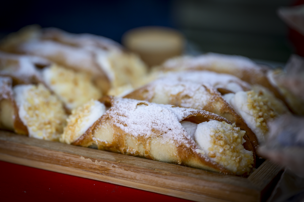 a photo showing freshly made traditional cannoli with ricotta filling
